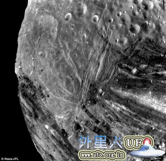 这是旅行者2号探测器在1986年1月24日最接近米兰达卫星前拍摄的照片。当时，这艘探测器距米兰达卫星1.9万英里。这颗卫星上的巨大断层峡谷比科罗拉多大峡谷深12倍。 第2张
